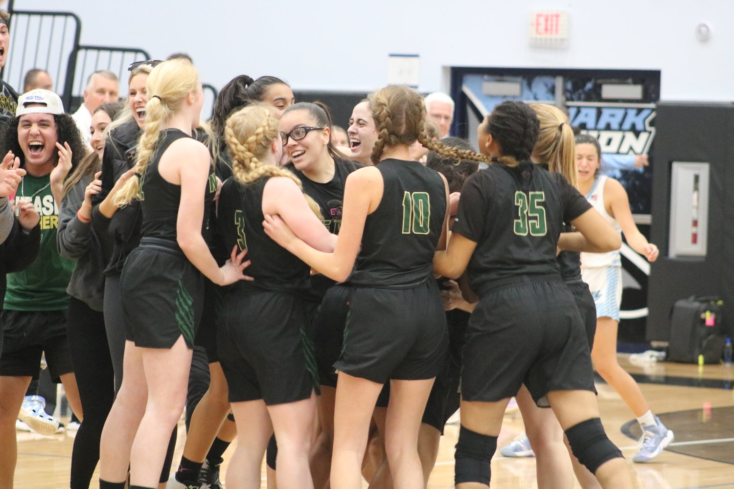 Nease senior Sydney Gomes is swarmed by her teammates after hitting the game-winning shot with five second left to beat rival Ponte Vedra 48-47 in the Class 6A regional quarterfinals Feb. 10.